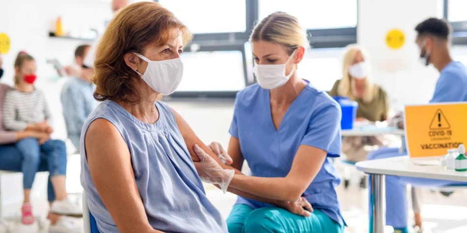 A woman receives a COVID-19 vaccine at a vaccination clinic.